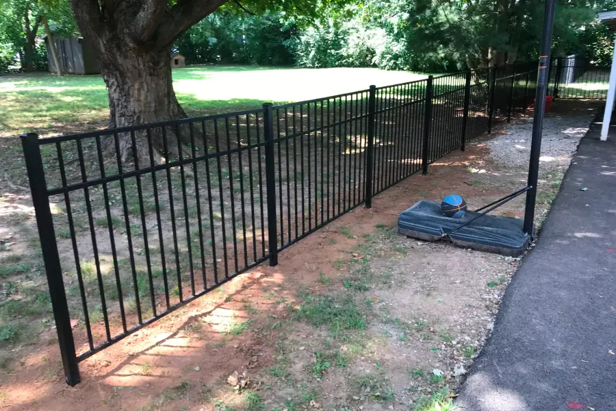 Black aluminum fence along a pasture