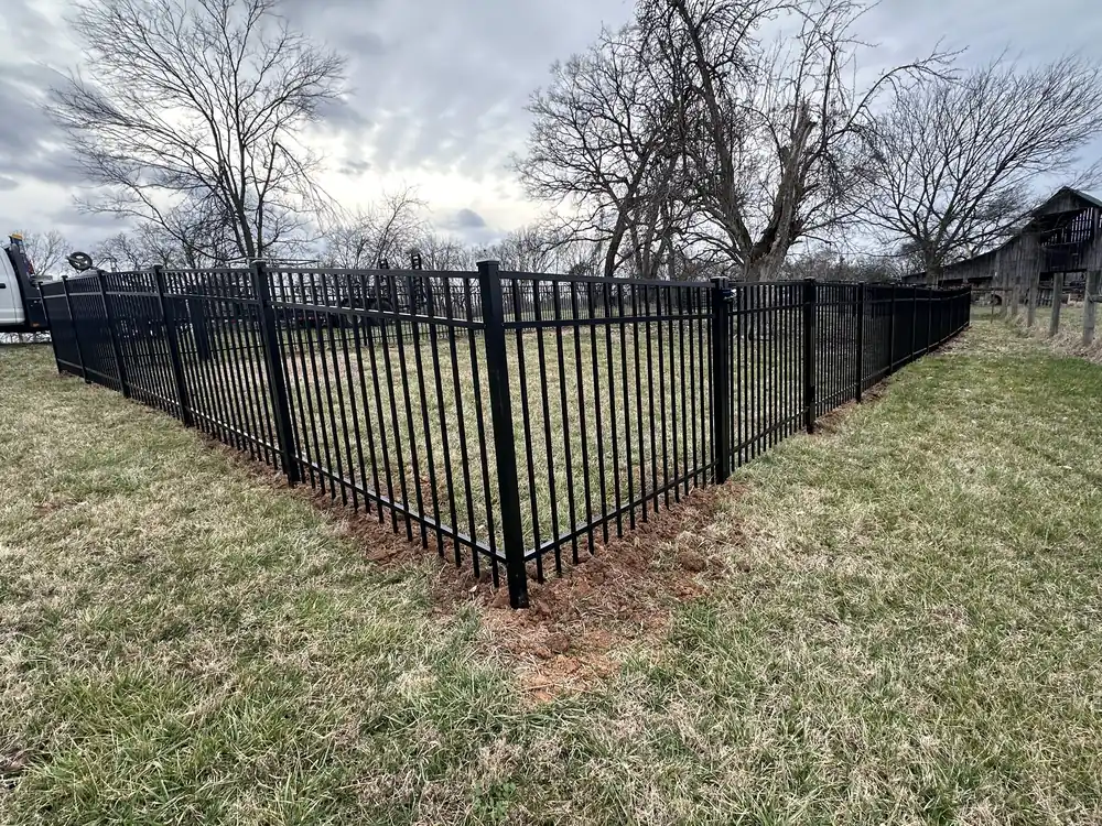 Black aluminum fence around a yard