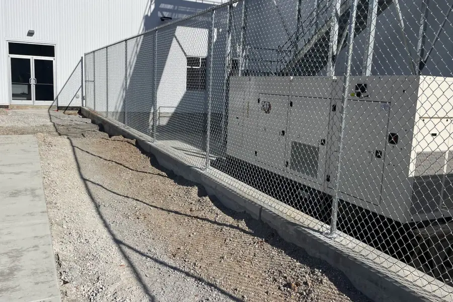 Chain link fence around commercial equipment