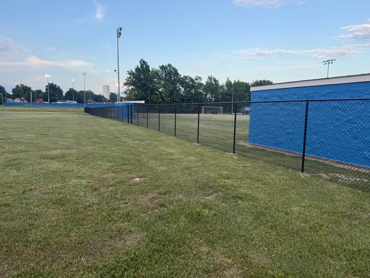 Black chain link fence around an athletic field