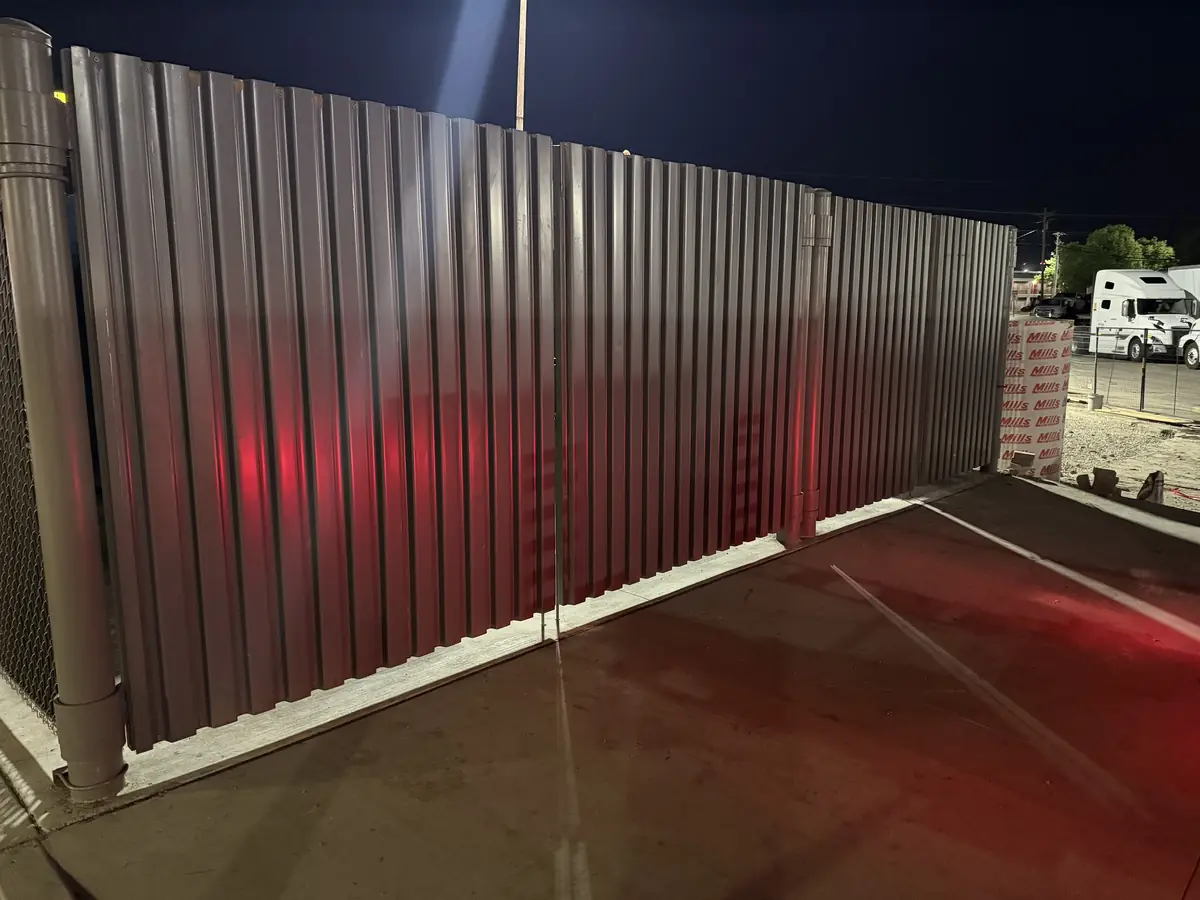 Steel panel privacy fence around a commercial site