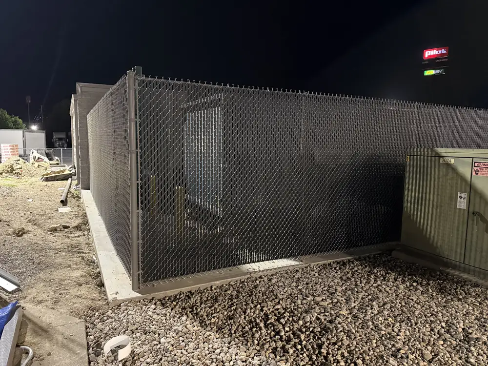 Chain link privacy enclosure at a commercial site