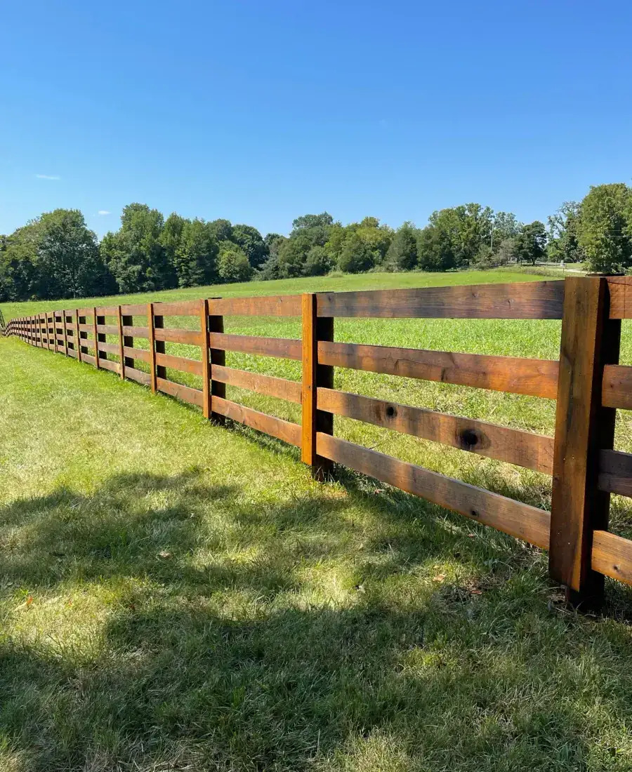 Stained plank farm fence