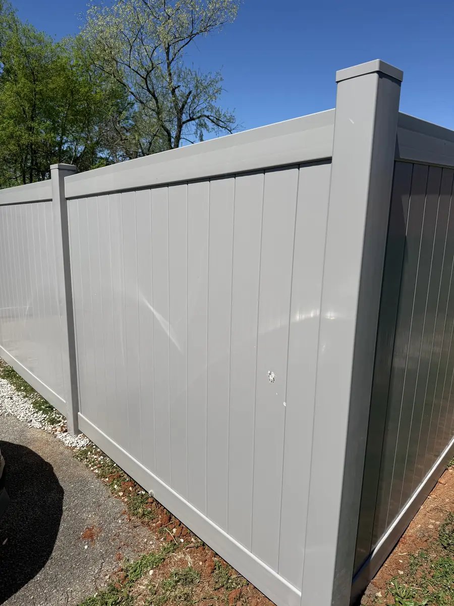 Gray vinyl privacy fence corner