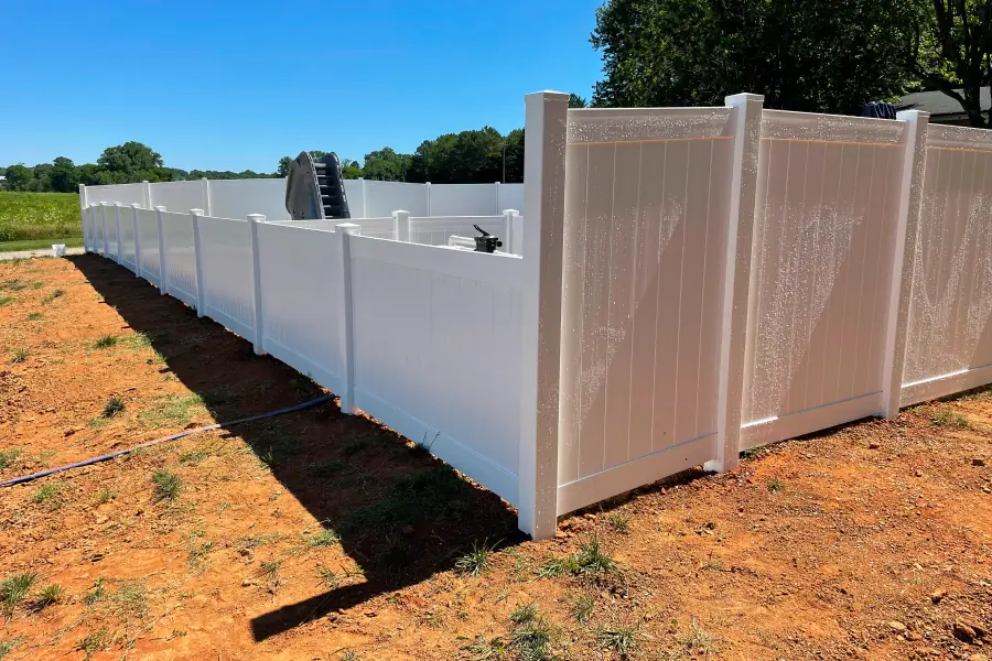 Tan vinyl privacy fence with lattice top