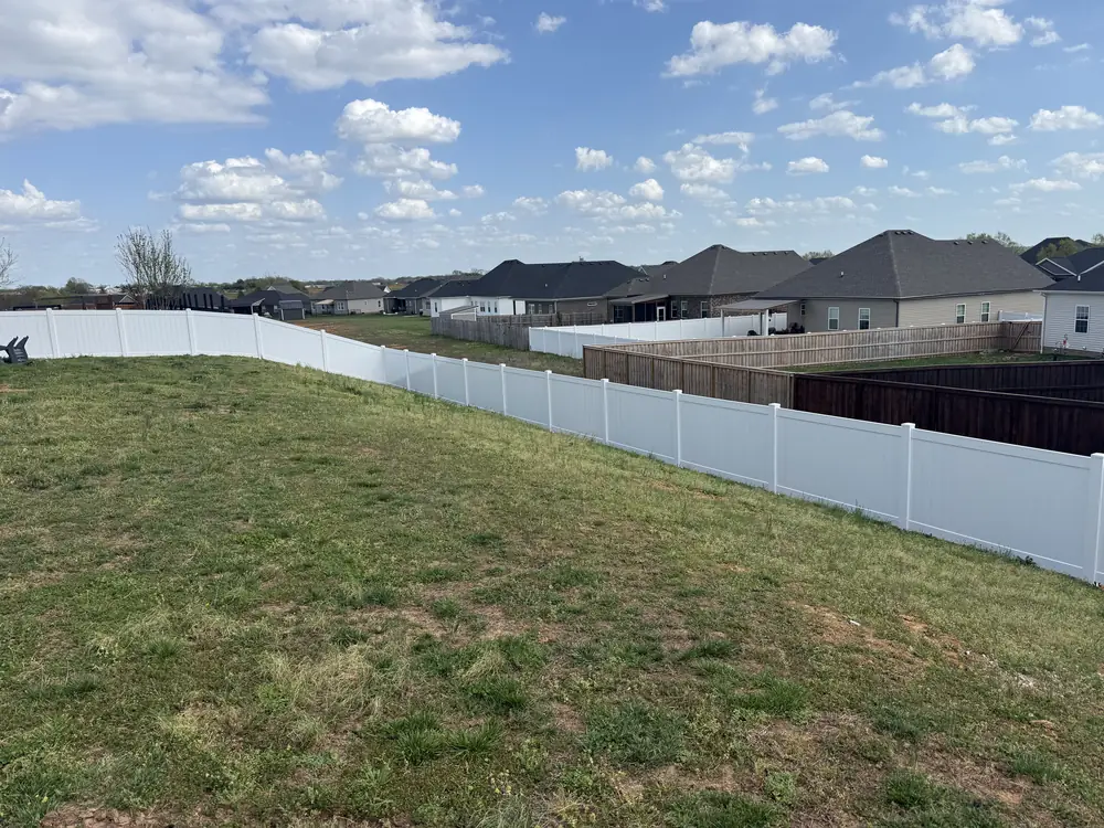 White vinyl privacy fence along a backyard
