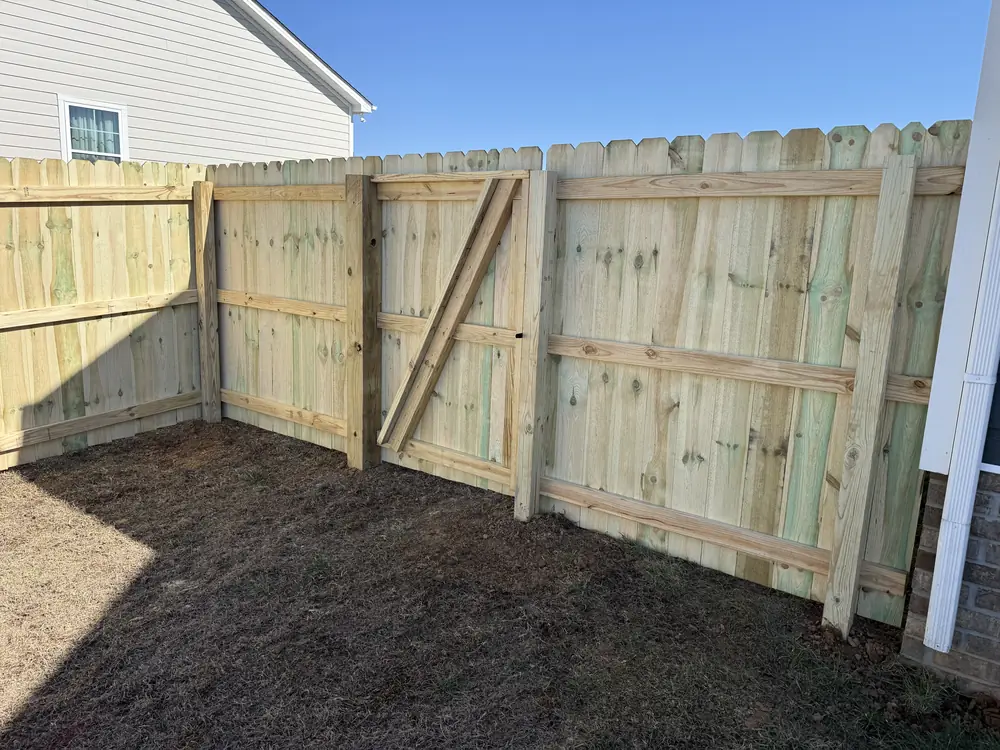 Pine privacy fence with a framed gate